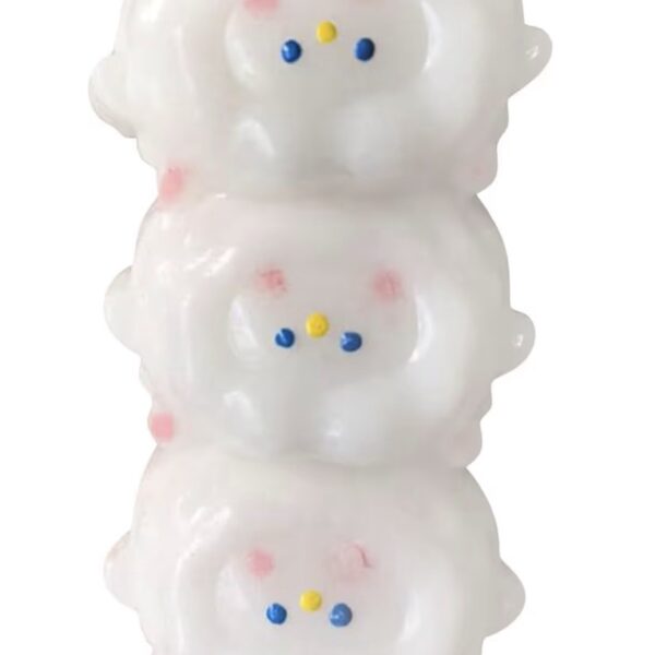 Three glossy white snowman figurines stacked vertically, each with pink cheeks, blue eyes, and yellow noses.