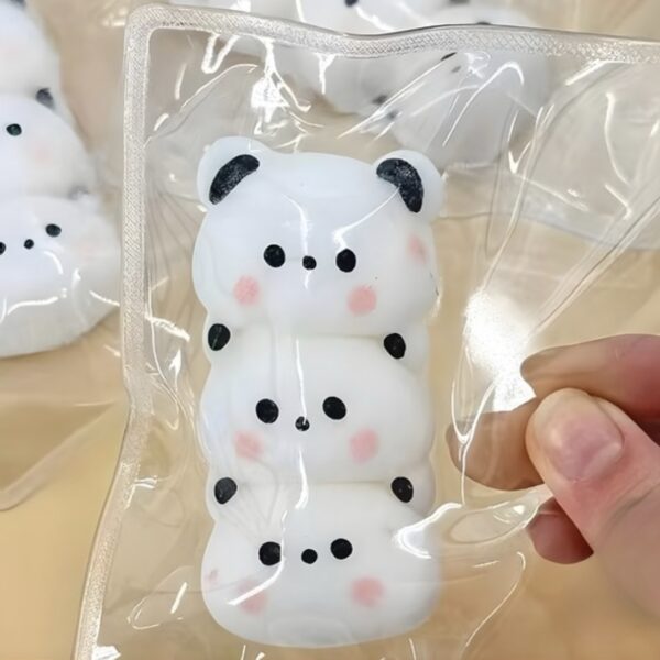 Three panda-shaped white candies stacked on top of each other with black ears, eyes, and pink cheeks, sealed in clear plastic packaging.